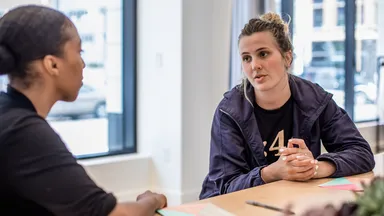 Two women discuss business